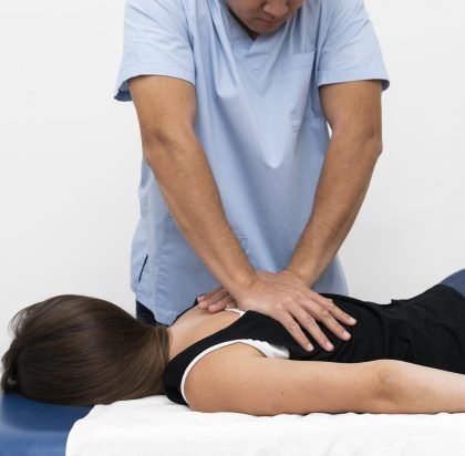 front-view-physiotherapist-massaging-woman-s-back
