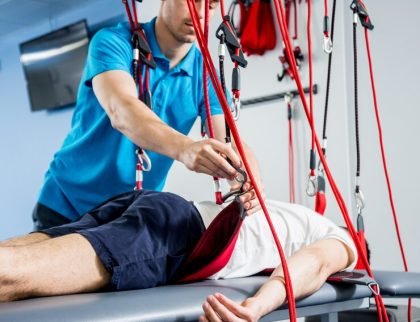 physiotherapy-suspension-training-therapy-young-man-doing-fitness-traction_179755-5440