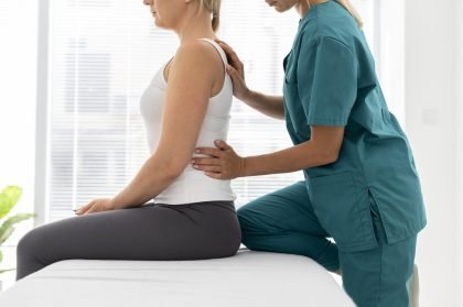 young-physiotherapist-helping-patient-with-back-problems